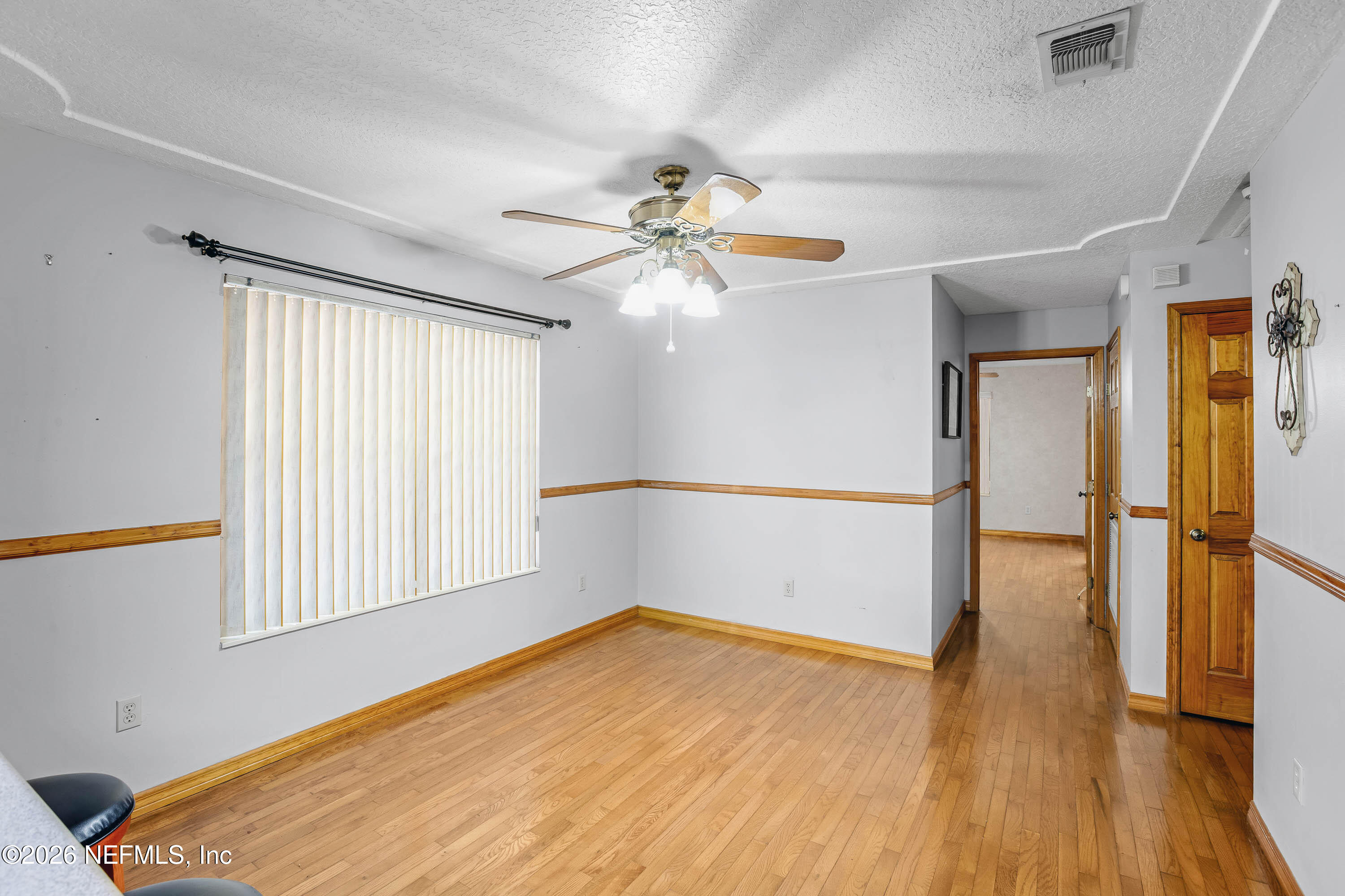 289 Chesser Road Interlachen, FL 32148 - Photo 10 of 63 wooden floor in an empty room with a window