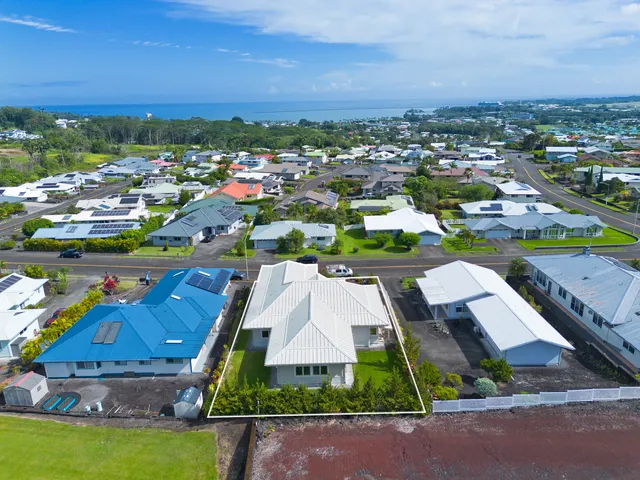 an aerial view of residential houses with outdoor space and swimming pool