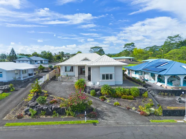 a view of house with a yard