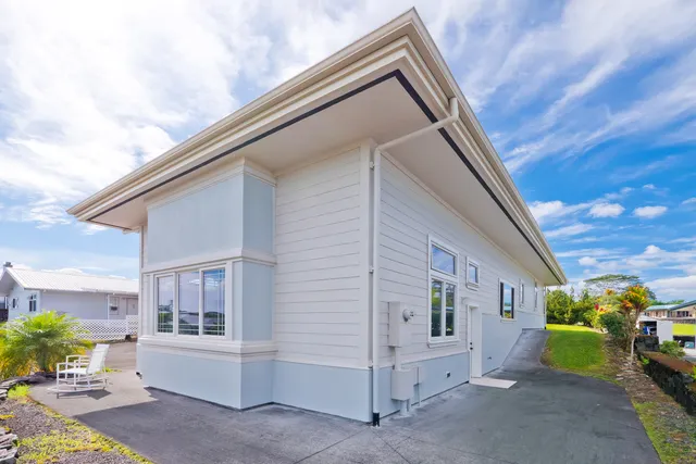 a view of house with swimming pool and glass windows
