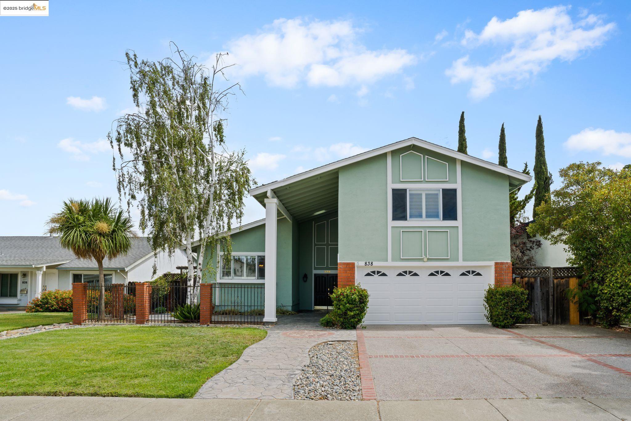 a front view of house with yard and green space