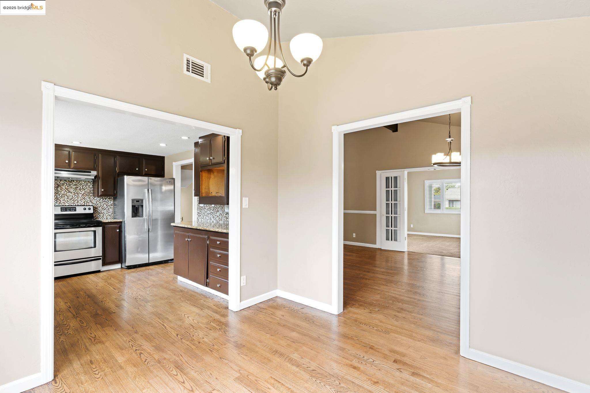 838 Hazel Street Livermore, CA 94550 - Photo 15 of 35 a view of a kitchen with a stove cabinets a ceiling fan and wooden floor