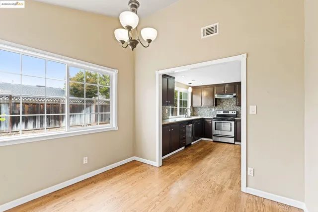 a view of a kitchen with a sink and wooden floor