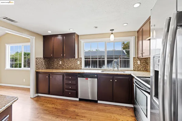 a kitchen with a sink and a large window