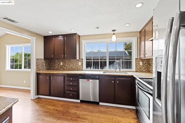 a kitchen with a sink and a large window