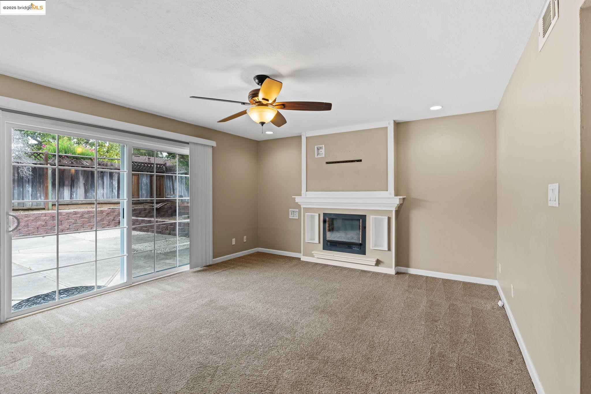 838 Hazel Street Livermore, CA 94550 - Photo 22 of 35 an empty room with windows and fireplace