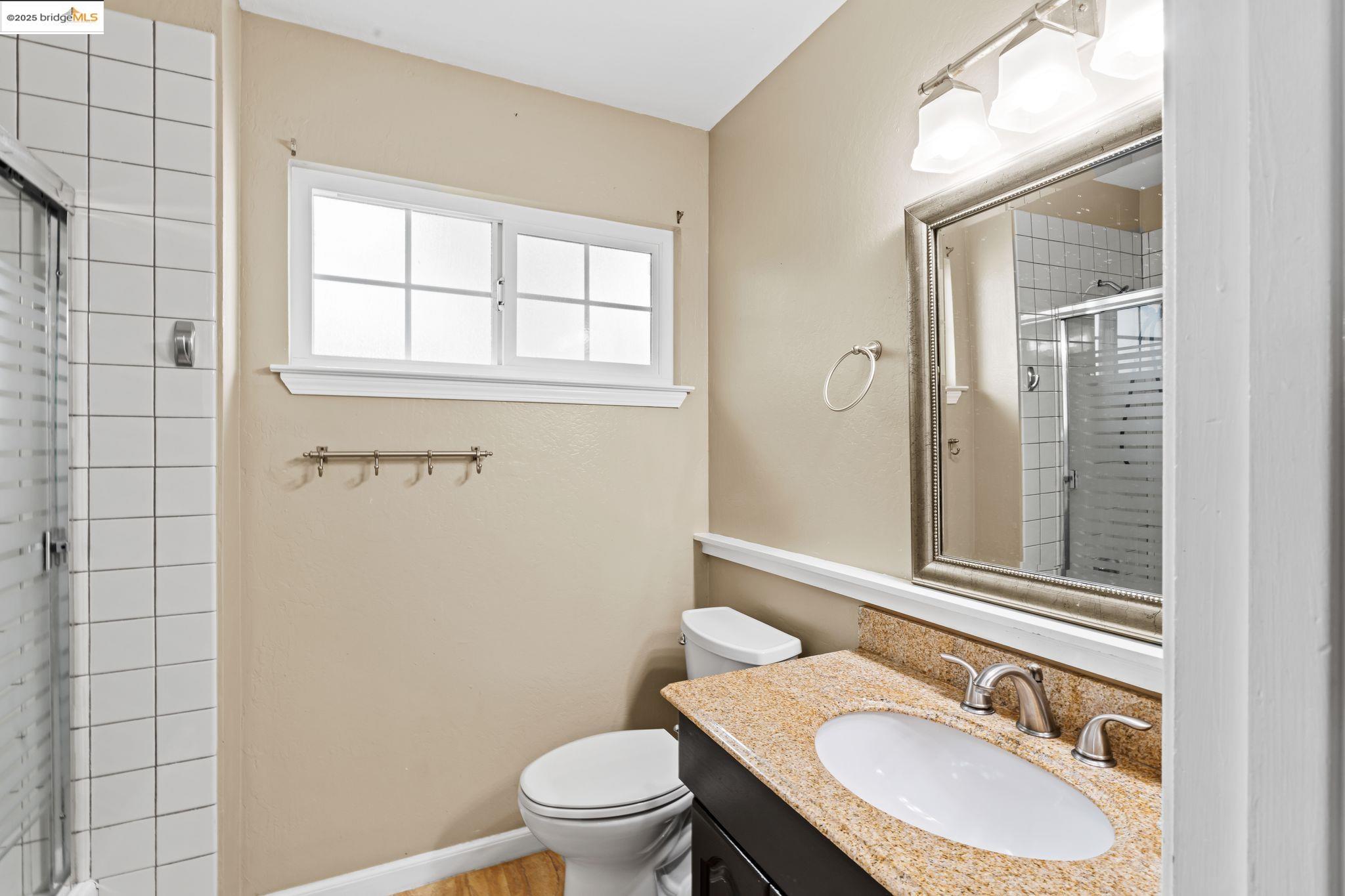838 Hazel Street Livermore, CA 94550 - Photo 27 of 35 a bathroom with a sink toilet a mirror and shower