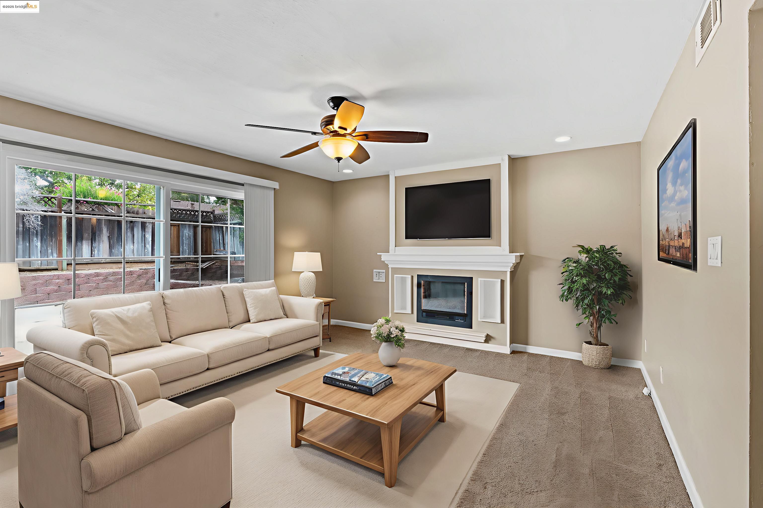 838 Hazel Street Livermore, CA 94550 - Photo 3 of 35 a living room with furniture a fireplace and a flat screen tv