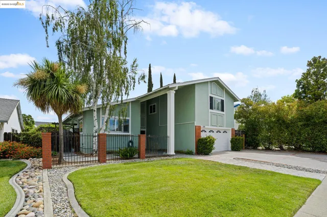 a view of a house with backyard and sitting area