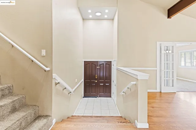 a view of a hallway view with wooden floor and staircase