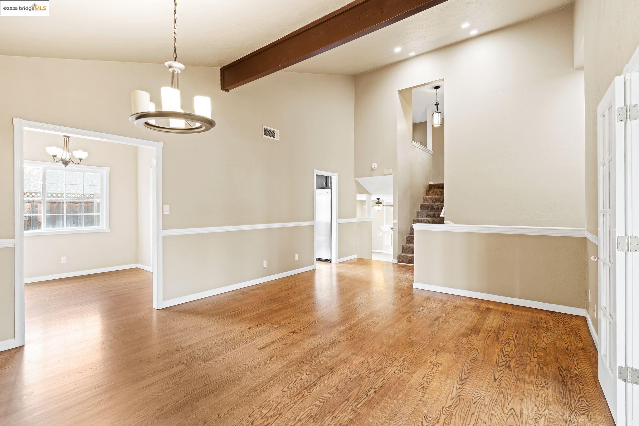 838 Hazel Street Livermore, CA 94550 - Photo 10 of 35 a view of a room with wooden floor a ceiling fan and windows