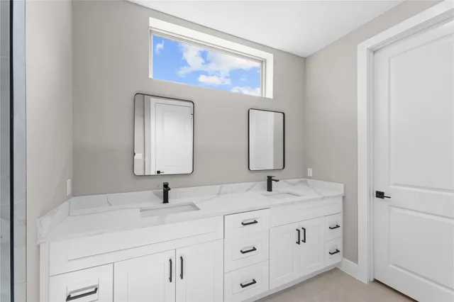 a bathroom with a granite countertop toilet a sink and shower