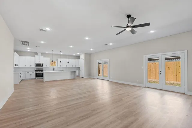 a view of a kitchen with a sink and wooden floor