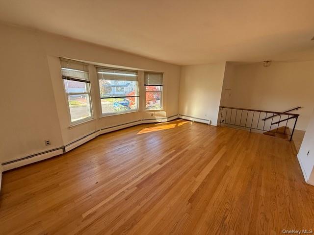 19 Carriage Road Roslyn, NY 11576 - Photo 3 of 19 an empty room with wooden floor and windows