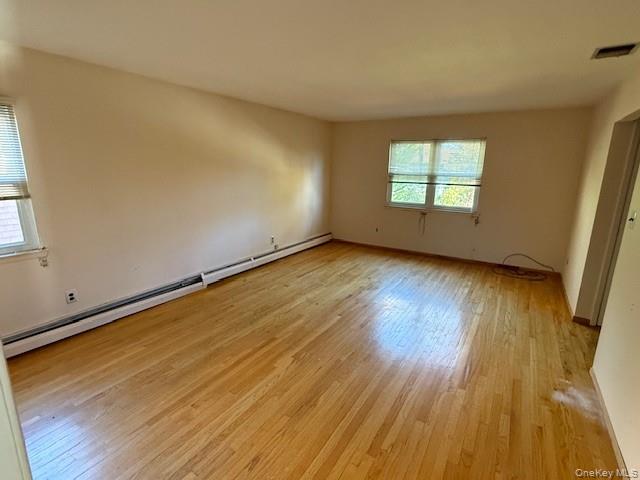 19 Carriage Road Roslyn, NY 11576 - Photo 8 of 19 an empty room with wooden floor and windows