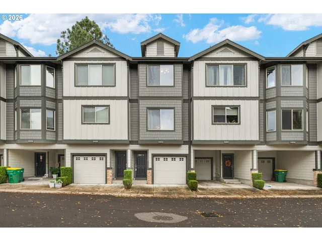 a front view of a residential apartment building with a yard