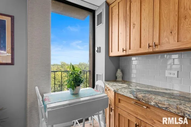 a kitchen with granite countertop cabinets stainless steel appliances a sink and a window
