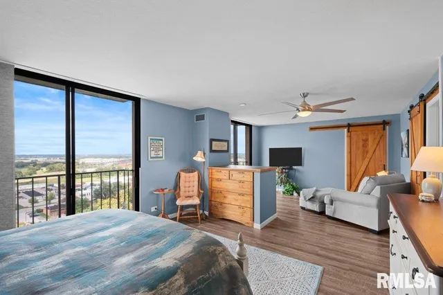 a bedroom with a large bed and a large window