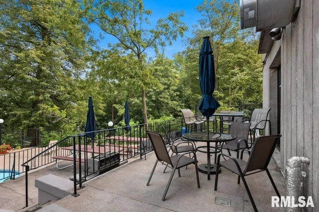 a view of a chairs and table in the balcony