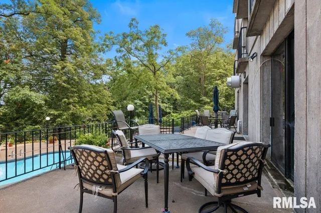 a view of a patio with a table and chairs