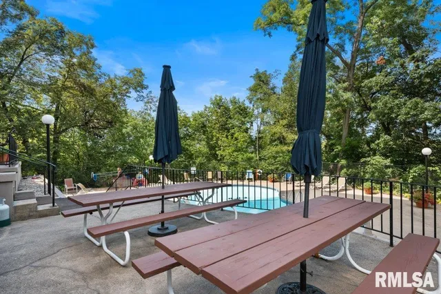 a view of a patio with a table and chairs