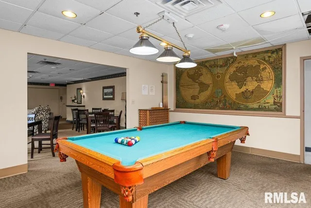 a room with pool table and window