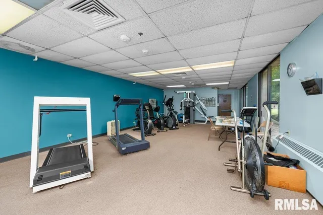 a room with gym equipment and windows