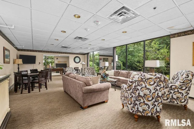 a living room with furniture large window and flat screen tv