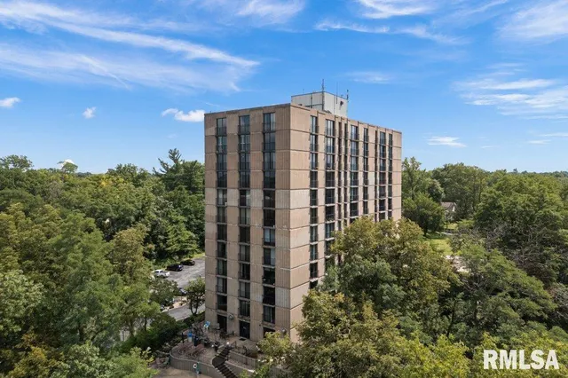 a view of a tall building in front of a city