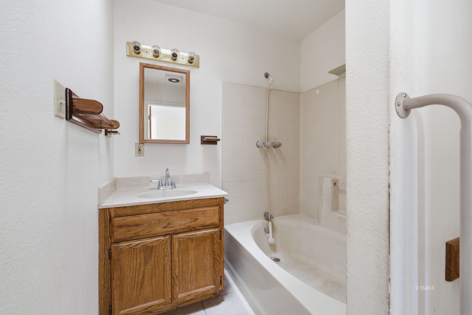 3443 3rd Street Inyokern, CA 93527 - Photo 12 of 24 a bathroom with a granite countertop sink a mirror and bathtub