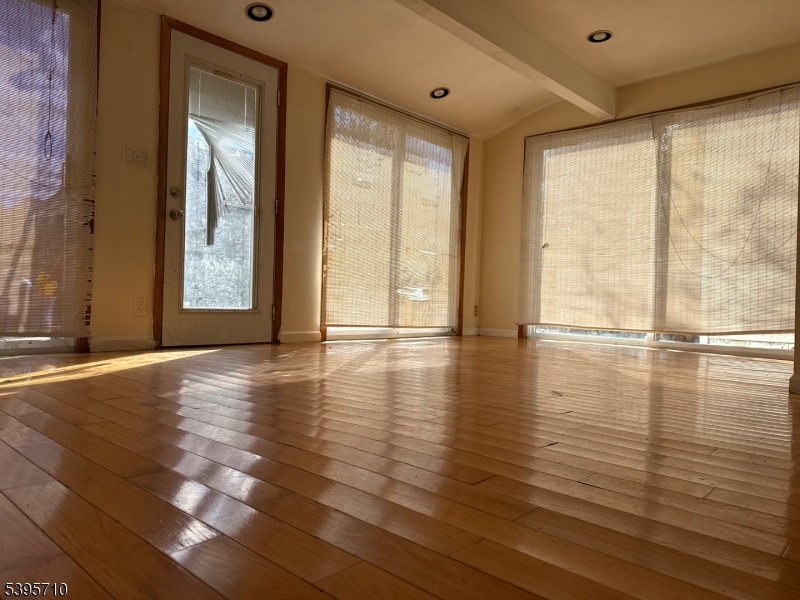 355 Metlars Lane Piscataway, NJ 08854 - Photo 11 of 26 a view of an empty room with wooden floor and a window