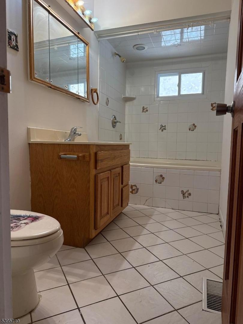355 Metlars Lane Piscataway, NJ 08854 - Photo 18 of 26 a bathroom with a sink a toilet and mirror