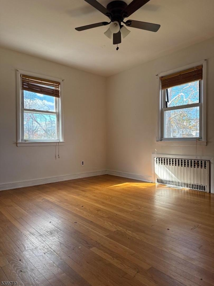 355 Metlars Lane Piscataway, NJ 08854 - Photo 20 of 26 an empty room with wooden floor and windows