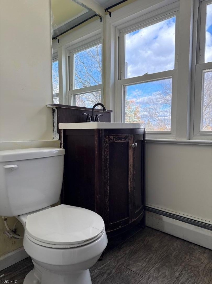 355 Metlars Lane Piscataway, NJ 08854 - Photo 23 of 26 a bathroom with a toilet a sink and a window