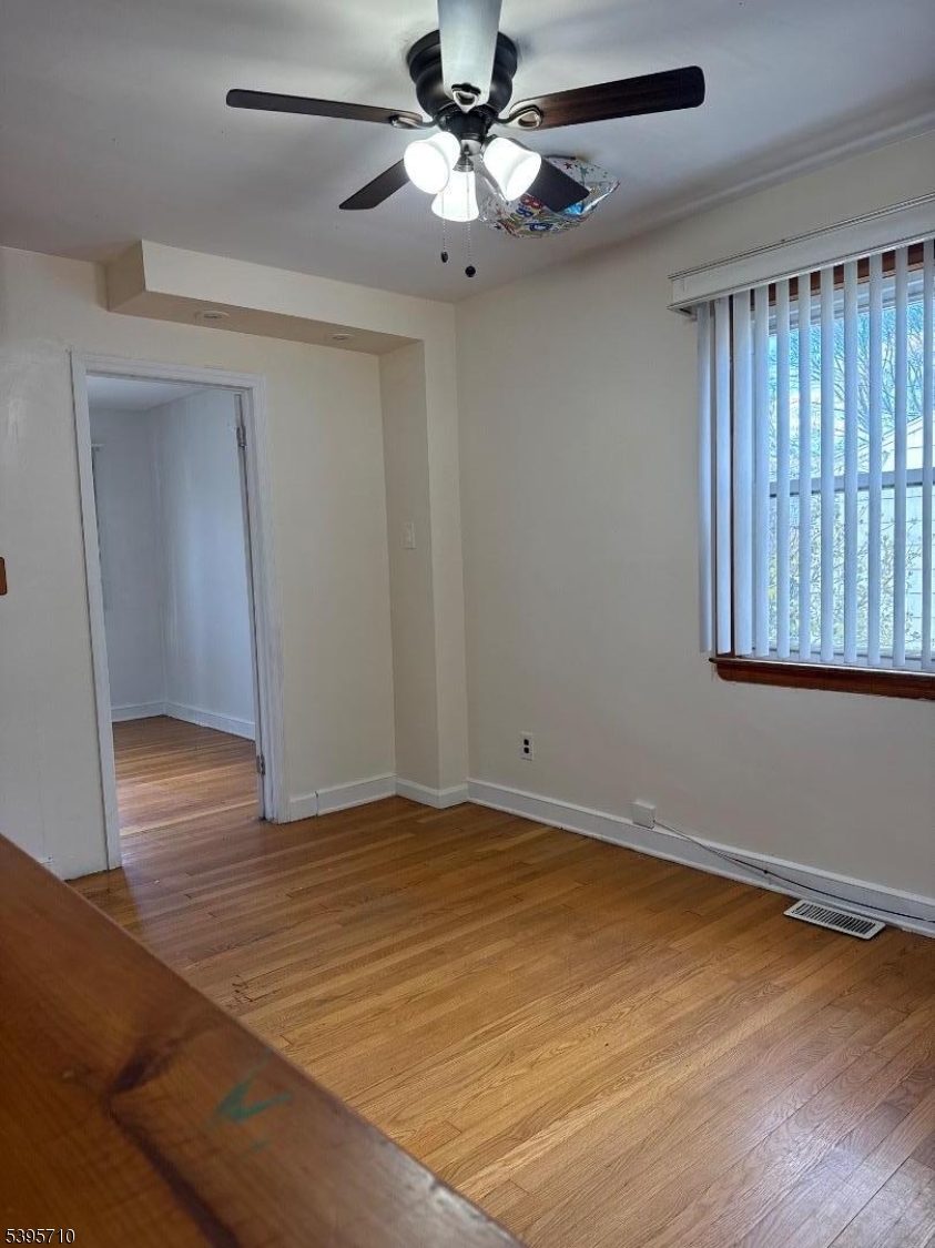 355 Metlars Lane Piscataway, NJ 08854 - Photo 26 of 26 a view of an empty room with wooden floor and a window