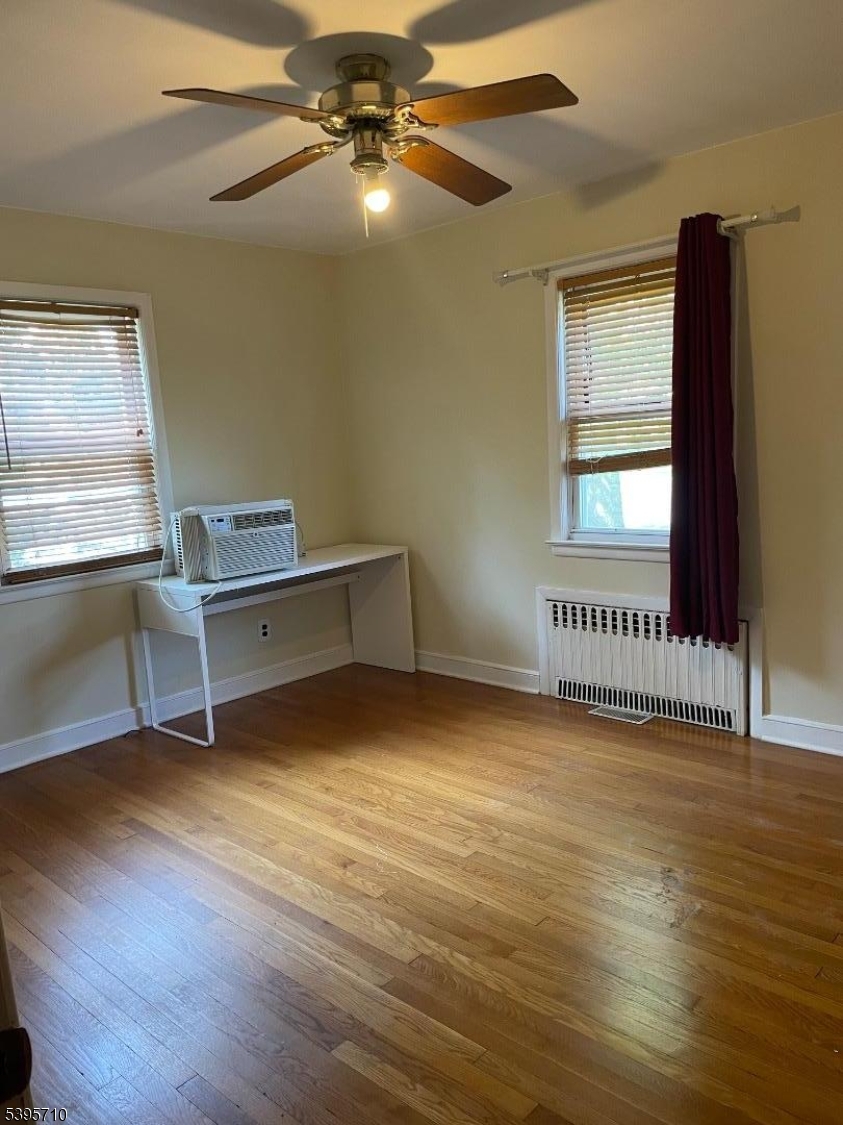 355 Metlars Lane Piscataway, NJ 08854 - Photo 3 of 26 a view of an empty room with a window and wooden floor