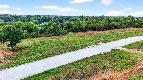 an aerial view of huge green field with lots of green space