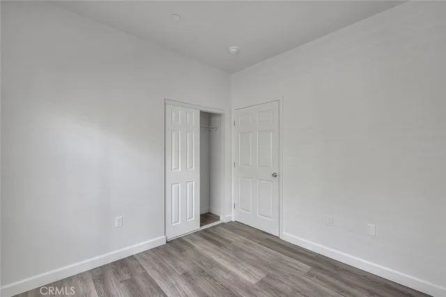 an empty room with wooden floor and a window