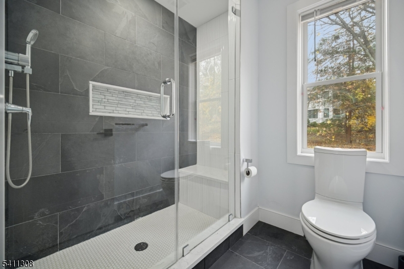 134 Hillside Avenue Livingston, NJ 07039 - Photo 14 of 25 a bathroom with a toilet and a shower