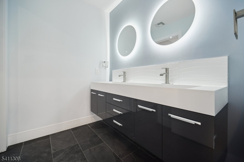 134 Hillside Avenue Livingston, NJ 07039 - Photo 15 of 25 a bathroom with a sink and a mirror