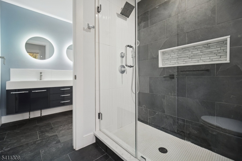 134 Hillside Avenue Livingston, NJ 07039 - Photo 16 of 25 a bathroom with a sink a toilet and shower