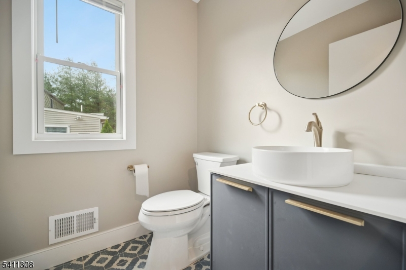 134 Hillside Avenue Livingston, NJ 07039 - Photo 17 of 25 a bathroom with a sink toilet and a mirror