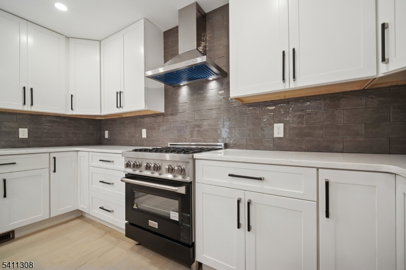 134 Hillside Avenue Livingston, NJ 07039 - Photo 6 of 25 a kitchen with white cabinets and white appliances