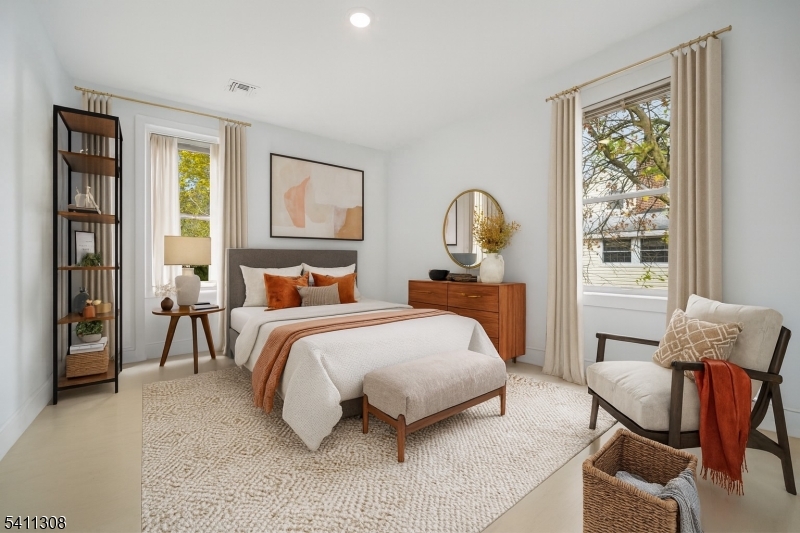 134 Hillside Avenue Livingston, NJ 07039 - Photo 8 of 25 a bed room with a bed and chair