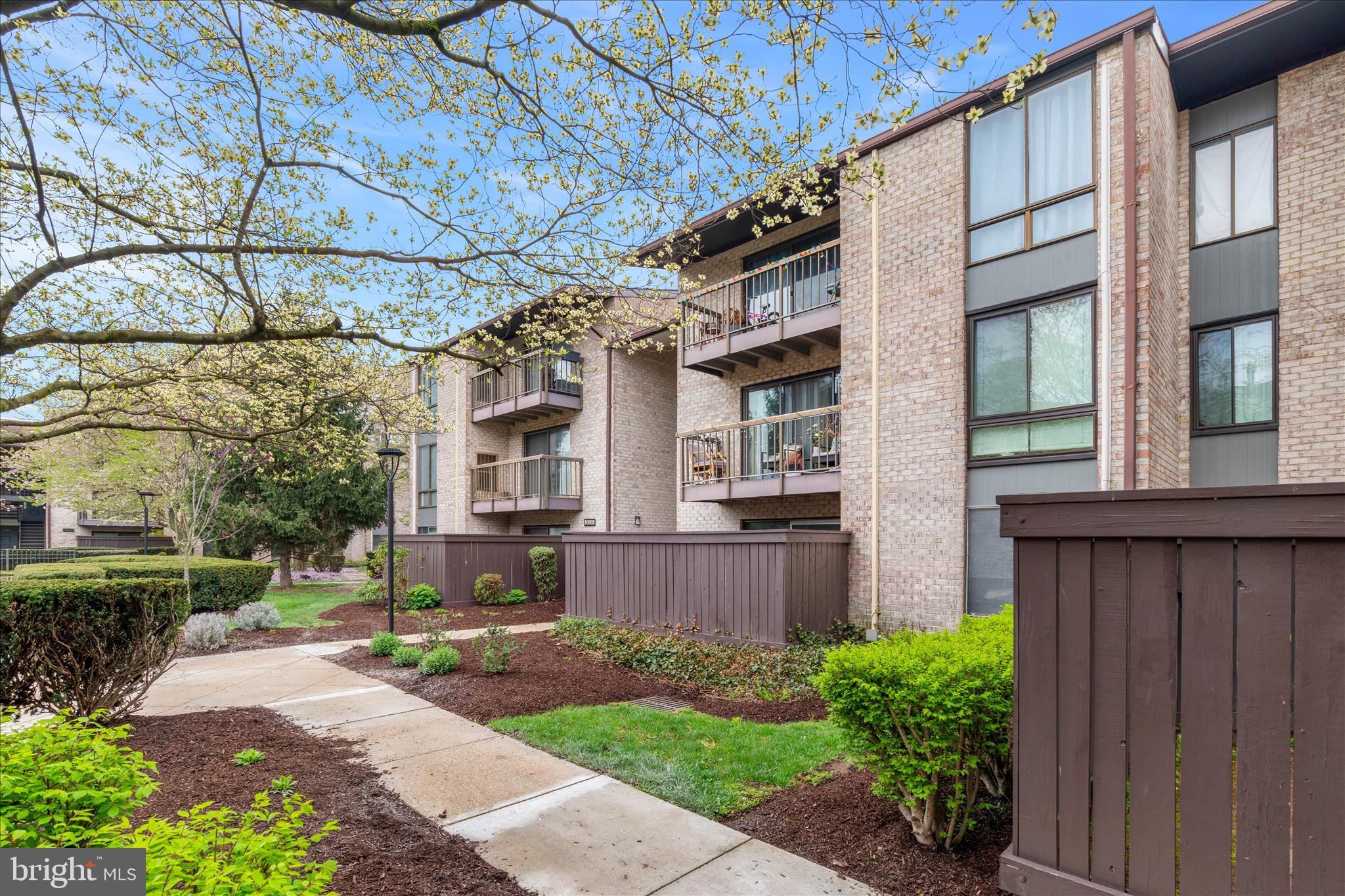 10000 Stedwick Road, Unit 104 Montgomery Village, MD 20886 - Photo 1 of 31 a view of a house with a yard and plants