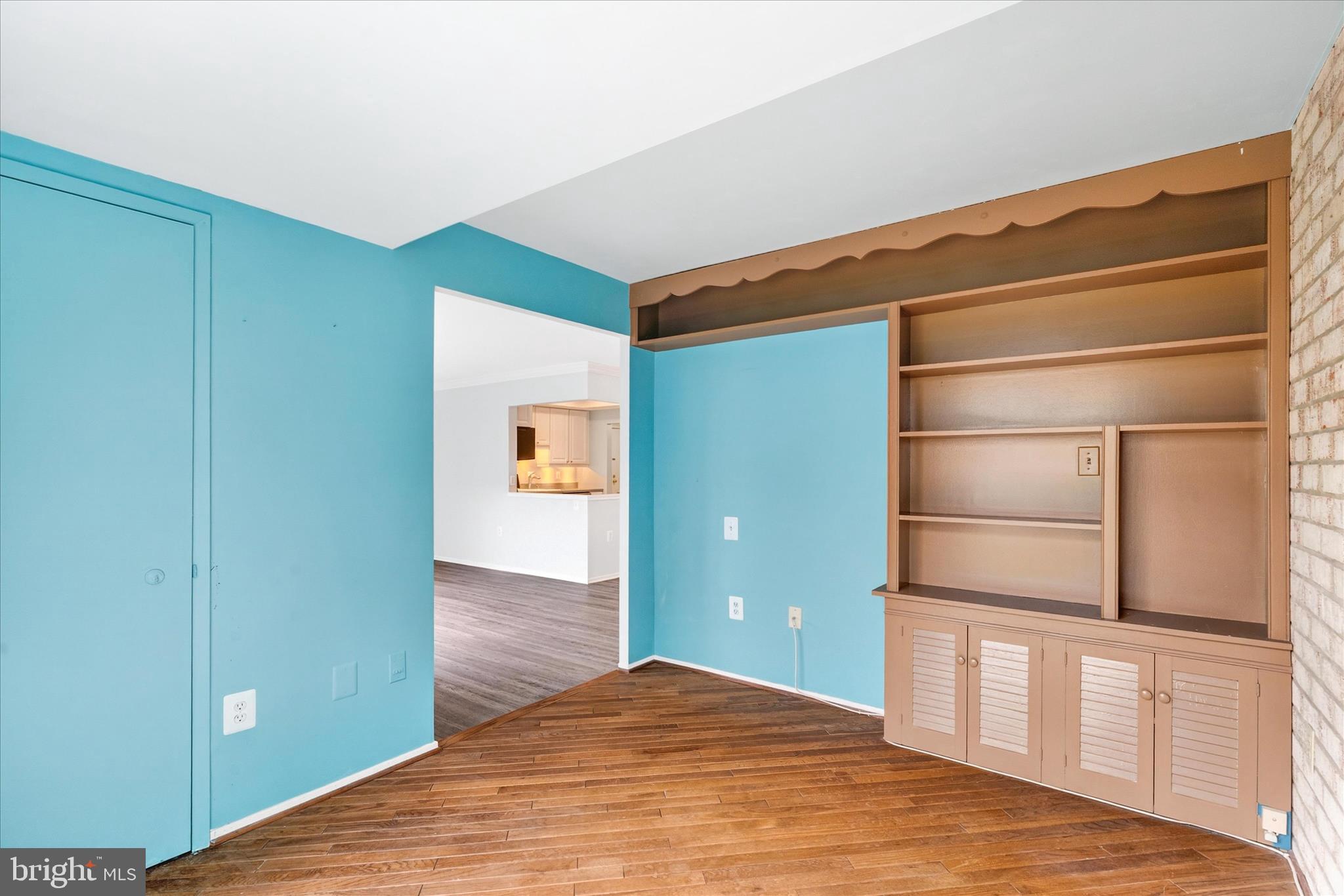 10000 Stedwick Road, Unit 104 Montgomery Village, MD 20886 - Photo 15 of 31 a view of an empty room with closet and wooden floor