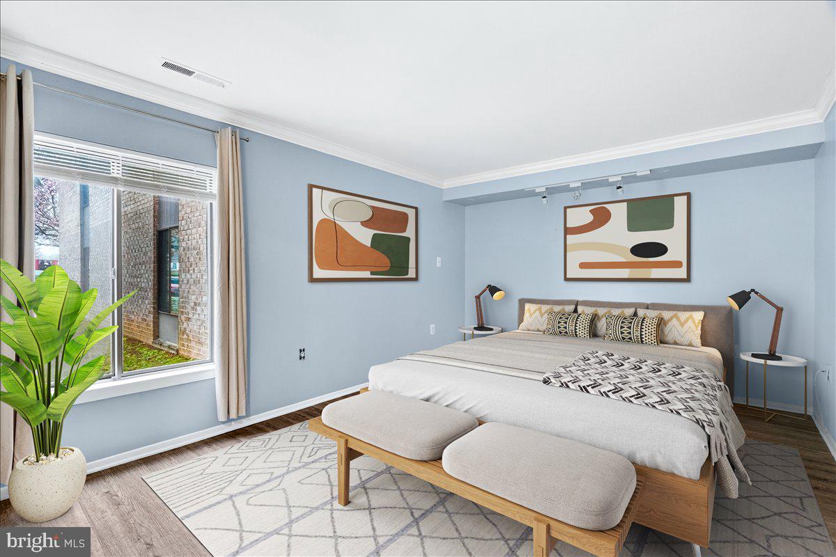 10000 Stedwick Road, Unit 104 Montgomery Village, MD 20886 - Photo 17 of 31 a bedroom with a bed and a potted plant