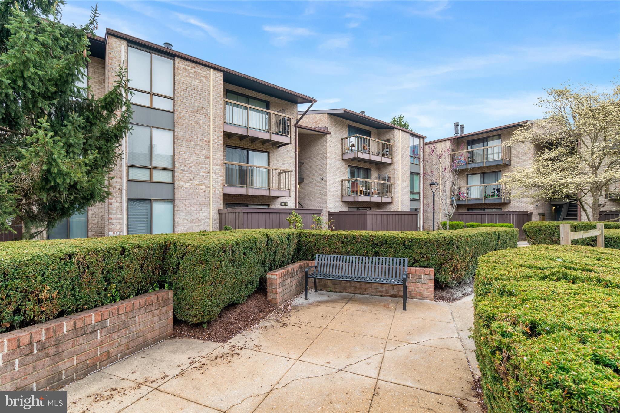 10000 Stedwick Road, Unit 104 Montgomery Village, MD 20886 - Photo 2 of 31 a view of a patio with couches table and chairs and potted plants