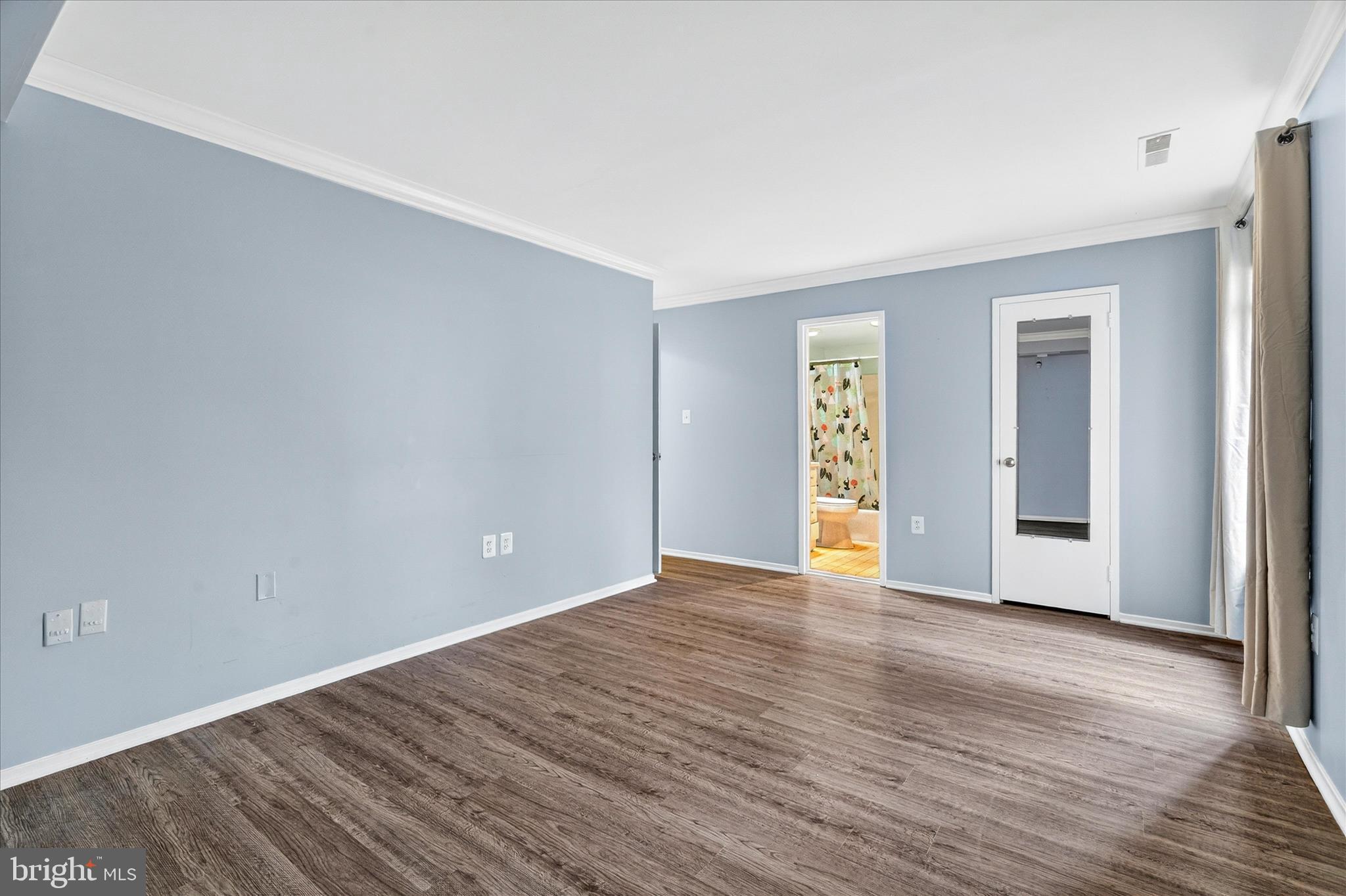 10000 Stedwick Road, Unit 104 Montgomery Village, MD 20886 - Photo 19 of 31 a view of an empty room with wooden floor
