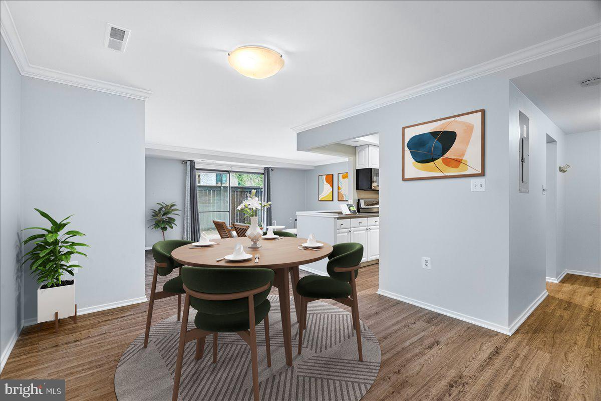 10000 Stedwick Road, Unit 104 Montgomery Village, MD 20886 - Photo 30 of 31 a view of a dining room with furniture and wooden floor